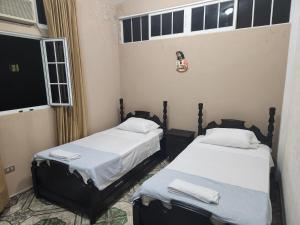 弗洛勒斯Hotel Casa de Don Francisco的带窗户的客房内设有两张单人床。