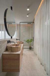 萨洛夫雷Salobre Oasis Suites的一间带两个盥洗盆和大镜子的浴室
