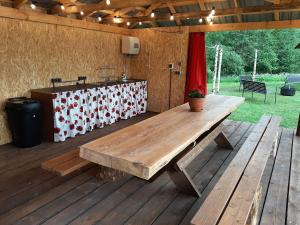 Suurepera puhkekeskuse saunamaja的木制甲板上的木餐桌