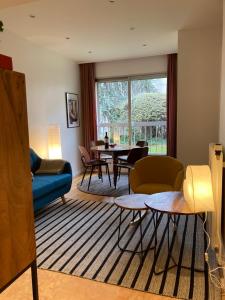 巴黎Vue sur jardin, 3 pièces的客厅配有蓝色的沙发和桌子