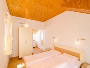 科洛塞普Holiday Home Macus的一间卧室设有两张床和木制天花板