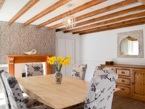 BroxaWhisperdale Barn的一间带木桌和椅子的用餐室