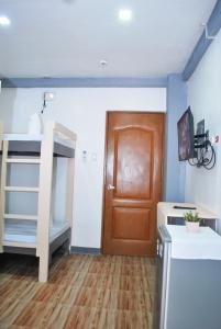 长滩岛WOZA INN BORACAY的客房设有双层床和木门。