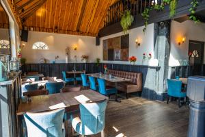 费尔森-需德Comfort Rooms by EuroParcs Buitenhuizen的餐厅设有木桌和蓝色椅子