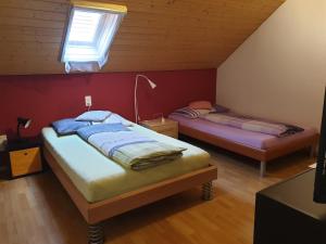 LeuzigenApartment Dorfstrasse 16的一间卧室设有两张床和窗户。