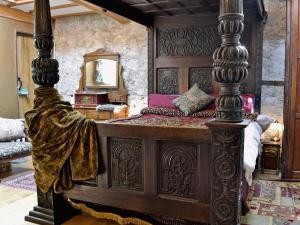 阿贝尔格莱亨利奇市政厅乡村别墅的一间卧室配有一张带镜子的大木床