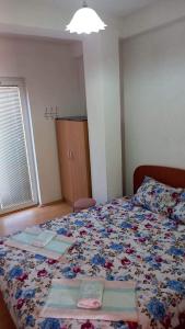佩斯塔尼Apartmani BAKULE的一间卧室配有一张带花卉床罩的床