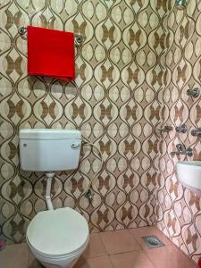 索拉哈Tiger Corner Inn Homestay的一间带卫生间的浴室和墙上的红色箱子