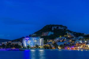 辛普森湾Atrium Beach Resort and Spa St Maarten a Ramada by Wyndham的夜晚从水面上欣赏城市美景