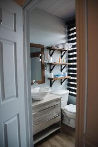 昂基博塞茹尔旅馆的一间带水槽、卫生间和镜子的浴室