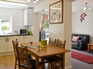 SwimbridgeMole的厨房以及带木桌和椅子的用餐室。