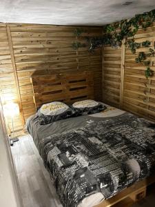 布里尼奥勒Appartement 2 chambres的一间卧室配有一张木墙床