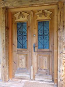BreitenbachBiohof Prem的两扇木门,房子上设有彩色玻璃窗