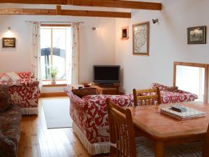 约翰奥格罗茨Mill Cottage的客厅配有桌子和沙发