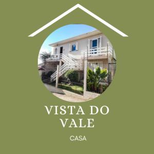 本图贡萨尔维斯Casa Vista do Vale próxima ao Vale dos Vinhedos的白色房屋的标志