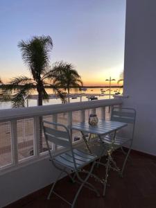 厄尔-汝姆披多Apartamento en primera línea de playa的海景阳台上的桌椅