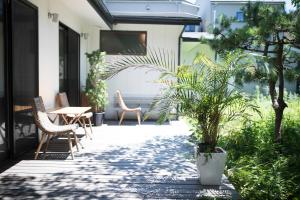 逗子市AMIGO HOUSE的庭院配有桌椅和植物