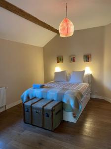 Sart-Dames-Avelines公鸡马厩乡村民宿的一间卧室配有一张铺有木地板的床。