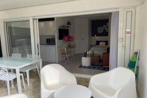 阿格德角Cap d' Agde Naturist Port Nature Villa 159的一间带桌椅的客厅和一间卧室