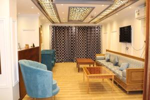 锡卜Al-Mwadda Hotel的大堂配有沙发、椅子和桌子