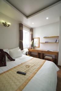 海防Trang Thanh Luxury Apartment的一间卧室配有一张带遥控器的床