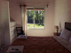 卢汉德库约Casa Ramal的一间卧室设有一张大床和一个窗户。