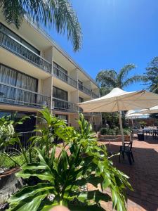 安特兰斯El Lago Waters Resort的配有雨伞和桌椅的酒店