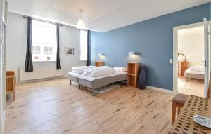 博恩瑟Det Gamle Gasvrk的一间卧室设有两张床和蓝色的墙壁