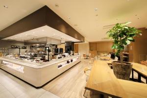 名古屋名古屋新干线口里士满酒店的餐厅内带桌子和柜台的大厨房