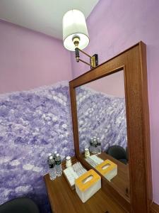 垦丁大街垦丁海晴天旅店的浴室设有镜子和台灯桌子