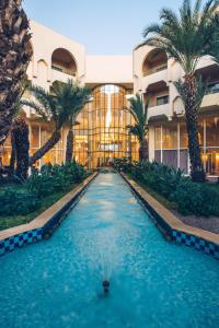 哈马马特伊波罗之星阿威罗伊酒店的棕榈树建筑前的游泳池