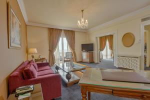 突尼斯突尼斯爱婆罗酒店的客厅配有红色沙发和电视