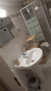 卡诺萨迪普利亚Casa - Torre dell'Orologio的浴室设有白色水槽和镜子