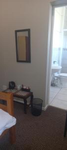 阿多The Kraal Addo的客房设有桌子、镜子和浴室