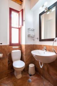 瓦若斯Lively Lofts by The Varos Residences的一间带卫生间、水槽和镜子的浴室