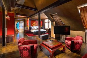 布拉格布拉格佛陀酒吧旅店的酒店客房,配有床铺和红色椅子