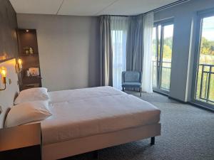 霍斯特霍斯特 - 芬洛公园酒店的配有一张床和一把椅子的酒店客房