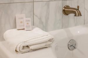 尼亚加拉瀑布红马车旅馆的浴室设有水槽,配有白色毛巾