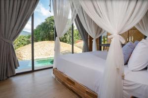 芭东海滩Three Monkeys Villas的一间卧室设有一张床,享有游泳池的景色