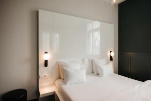 赖斯韦克Hotel & Spa Savarin - Rijswijk, The Hague的卧室配有白色大床和白色枕头