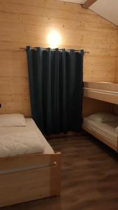 Lepin-le-LacLa tanière du lac d Aiguebelette的一间设有两张床和黑色窗帘的房间