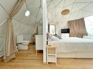 ArafoDomo Volcano Suite Experience的一间卧室设有一张床铺和卫生间的帐篷