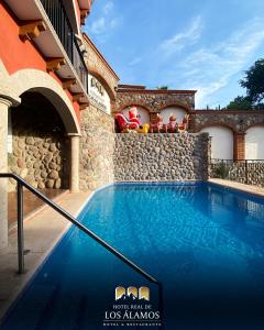 阿拉莫斯Hotel Real de los Alamos的一座石墙房子内的游泳池