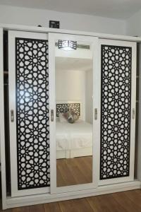 加利布港Marina city port ghalib chalet的客房设有带镜子和床的卧室