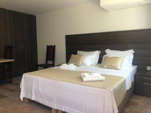 曼德雷Luxury Apartments White Villa Violeta的一间卧室配有一张大床和毛巾