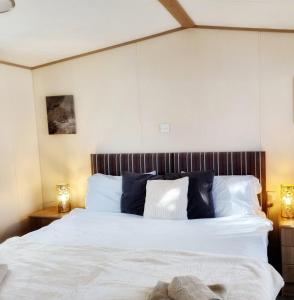 Porchfield31 solent village的一间卧室配有带白色床单和蓝色枕头的床。