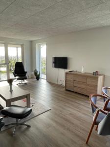 海宁Nyt hus的客厅配有平面电视和椅子