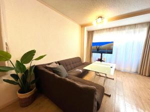 大阪Nao's Guesthouse 2 一軒家貸切的客厅配有沙发和桌子