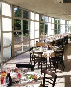 布克港伊加德公寓酒店的一间设有桌椅和窗户的长餐厅