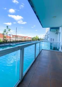 日惹Marda Room By Vivo Apartment的从带游泳池的大楼的阳台上可欣赏到风景